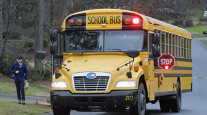 A Cobb County School bus moves on street.