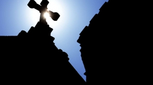 The silhouette of a cross on a Catholic church