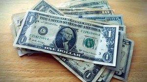 A stack of money on a table.