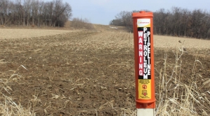 An Enbridge post marks the Line 61 corridor in a field in Marshall, Wisconsin.