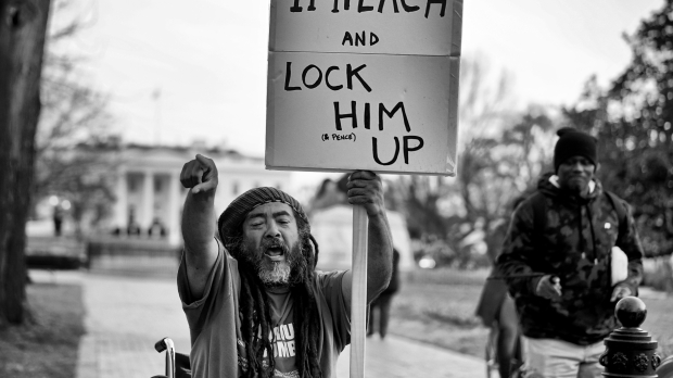 A protester calling for Trump's imprisonment