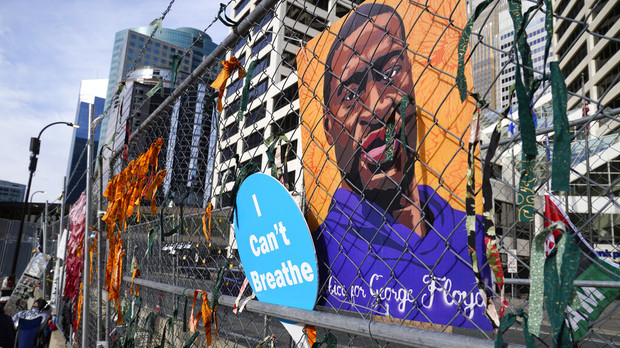 A picture of George Floyd hangs on a fence outside the Hennepin County Government Center