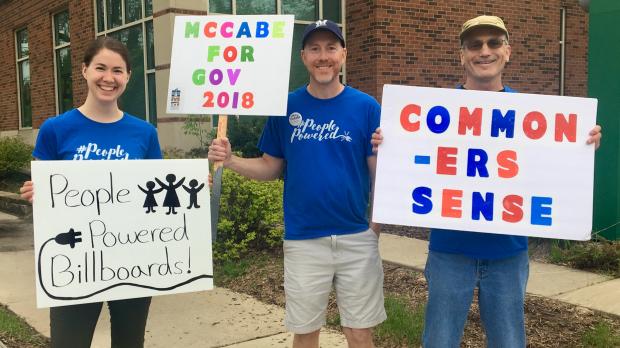 McCabe supporters hold signs outside a McCabe campaign event McCabe supporters hold signs outside a McCabe campaign event