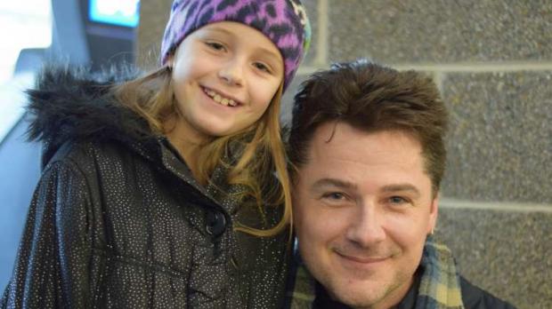Kirk Stone and his 9-year-old daughter pose together during their interview