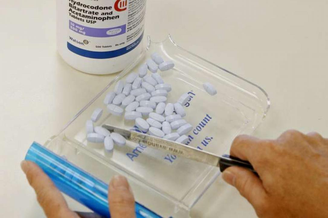 Photo of someone portioning a tray of medical pills